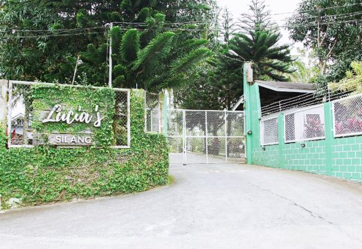 Lucia's Silang entrance gate with lush greenery