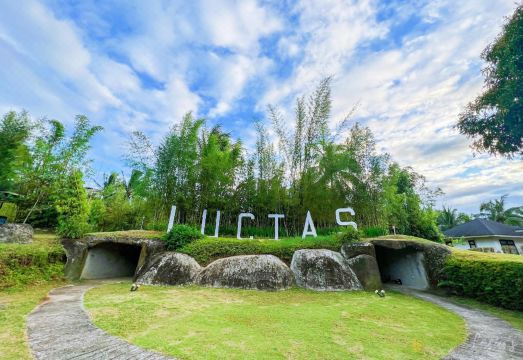 The iconic LUCIA'S sign surrounded by bamboo and landscaped gardens
